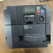3G3MX2-A4040-V2 with the heatsink visible, terminal cover open showing the input/output power terminals and STO input