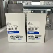 Omron 61F-G3 AC100-220V — front face of two units next to each other, label and screw visible