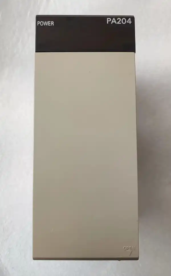 Omron C200HW-PA204 power supply -- front face of the C200H supply mounted in the leftmost slot of a C200HW-BI081 8-slot backplane, AC input terminals on top.