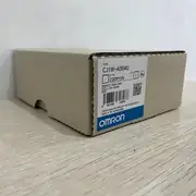 Omron CJ1W-AD04U — installed on a CJ-series backplane next to a CJ1M CPU and a CJ1W-ID211 digital input unit, with shielded twisted pair wiring into the removable terminal block