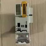 Omron CJ1W-AD081-V1 — side view showing the bus connector strip on the left that links to the CJ-series rack and the module latch on the back of the housing