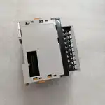 Omron CJ1W-AD081-V1 installed on a CJ rack with shielded twisted-pair analog wiring landed on the detachable terminal block, paired with a CJ1W-DA041 output module to the right