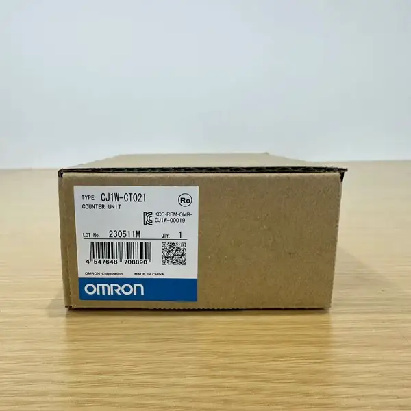 Omron CJ1W-CT021 — brown Omron product box with the CJ1W-CT021 / COUNTER UNIT type label, lot 230511M, OMRON Corporation mark, and a KC certification stamp