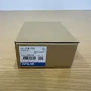 Omron CJ1W-CT021 — second box at a slightly different angle on a wooden surface, showing the same CJ1W-CT021 / COUNTER UNIT type label and lot number stamp