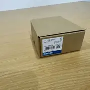 Omron CJ1W-CT021 — higher-angle view of the brown product box showing the top flap and the side label with KC mark and barcode