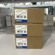 Omron CJ1W-CT021 — stack of three brown Omron counter unit boxes on a warehouse shelf, each tagged with the CJ1W-CT021 type label and different lots (230607M, 230607M, 230920M)