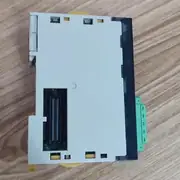 Omron CJ1W-DRM21 DeviceNet unit — side view showing the CJ bus connector strip on the left for mounting on the CJ-series backplane, and the unit-width 31 mm slim form factor
