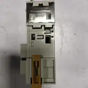 Omron CJ1W-ETN21 — dark grey slim CPU-bus module installed on a CJ backplane, viewed from below showing the backplane connector and right-side terminal block