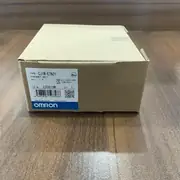 Omron CJ1W-ETN21 — brown Omron cardboard shipping carton with TYPE CJ1W-ETN21 ETHERNET UNIT label, Ver. 1.5, KCC-REM-OMR-CJ1W-00017 KC mark, lot 230819M, barcode, blue-and-white OMRON band along the bottom, MADE IN CHINA