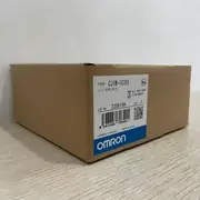 Omron CJ1W-IC101 I/O Control Unit — installed on a CJ2M-CPU33 CPU rack between the CPU and the first CJ1W-ID211 input module, with a CS1W-CN223 cable connecting the IC101 to a CJ1W-II101 on the first expansion rack