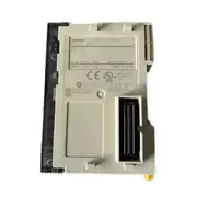 Omron CJ1W-ID261 — side view showing the DIN-rail latch on the back of the module and the bus connector strip that links to the adjacent CJ-series power supply and CPU