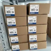 Omron CJ1W-ID262 — brown Omron-branded cardboard shipping carton with the CJ1W-ID262 type label, the DC Input Unit subtext, the Ver. 1.0 subtext, the KCC-REM-OMR-CJ1W-00015 KC mark, the lot number 230511M, the barcode, and the blue-and-white OMRON band along the bottom