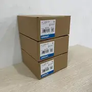 Omron CJ1W-II101 I/O Interface Unit — installed on a CJ1W expansion rack between the CJ1W-PD025 power supply and the first CJ1W-OC211 output module, with a CS1W-CN223 cable connecting it back to the CJ1W-IC101 on the CPU rack