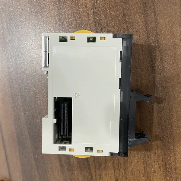 Omron CJ1W-MD232 in its shipping carton with the type label, Omron logo, and slim 31 mm module profile visible