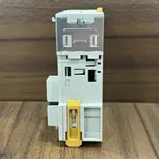 Omron CJ1W-NC413 — DIN-rail mounted side view of the module showing the silver metal mounting clip at the top, the yellow backplane-release lever at the bottom labelled "PUSH" with arrow, the white plastic slim-body housing, and the backplane mating slot