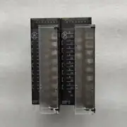 Omron CJ1W-OC201 8-point independent-relay output unit — front view showing the 24-position removable screw terminal block with three terminals per output (C, NO, NC), so each of 8 outputs is fully isolated
