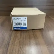 Omron CJ1W-OD232 sealed in its shipping carton with the type label, Omron logo, and barcode visible