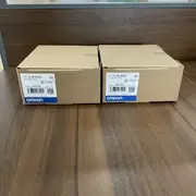 Two CJ1W-OD262 shipping boxes side by side showing the same type label on both, with the cardboard sealed at top and bottom