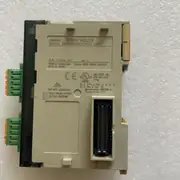 Omron CJ1W-SCU32 — single SCU32 module on an off-white surface showing the OMRON wordmark / CJ1W-SCU32 SERIAL COMMUNICATION UNIT label / Lot No. 170825K 0007 / Ver. 2.1 / OMRON Corporation Kyoto, 600-8530 JAPAN / CE / cULus LISTED 7T7M IND. CONT. EQ. FOR HAZ. LOC. / Cl. I, DIV. 2 Gp. A, B, C, D / Cl. I, Zn. 2, Gp. IIC / See Instruction: 09872090-3 / Temp. Code T4A / NK APP.<02A001> / KCC-REM-OMR-CJ1W-00038 / two green 5-pin RS-422A/485 terminal blocks on the left / 40-pin backplane connector on the right edge
