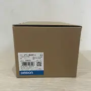 Omron CP1L-M40DR-A compact PLC — installed in a small packaging machine panel with 24 VDC inputs from sensors, 16 relay outputs driving solenoid valves, and a USB programming cable connected to a PC running CX-Programmer