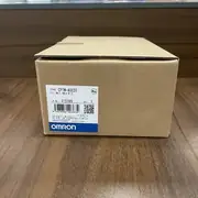 Omron CP1W-40EDT — top label close-up showing the part number, the 24 VDC rating, and the input/output count on the dark grey housing