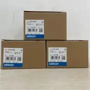 Omron CP1W-AD042 4-channel analog input expansion unit — installed on the right side of a CP1L-EM40DT1-D PLC with 2 × 4-20 mA pressure transmitters and 2 × 0-10 V flow transmitters wired into the four input channels