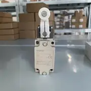 Omron D4B-4111N aluminum safety limit switch — top view showing the cover with 4 × M4 cover screws and the model-number label with the D4B-4111N (1NC/1NO snap-action DOM) designation