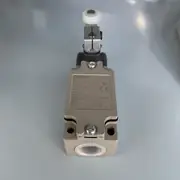 Omron D4B-4111N aluminum safety limit switch — installed on an outdoor water-treatment-cabinet door; the lever rides against the door-frame striker, NC contact wired to a G9SE-201 safety relay that trips when the cabinet opens