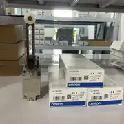 Omron D4B-4116N limit switch — installed at the end of a conveyor transfer arm with the roller lever riding the cam profile and the M20-conduit cable routed back to the cabinet