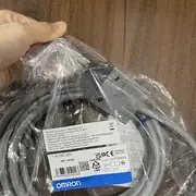Omron D4C-1220 slim limit switch — top view showing the cover with 2 × M3 screws, the model-number label with the D4C-1220 (roller lever high-sensitivity) designation, and the IP67 seal gasket visible