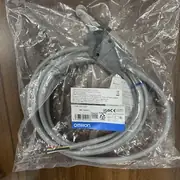 Omron D4C-1220 slim limit switch — bottom view showing the actuator lever bottom surface (where it contacts the cam/striker) and the 25 mm mounting hole pattern