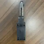 Omron D4N-112G safety limit switch — rear view showing the back of the plastic housing with the M3.5 screw terminals for the 1NC/1NO contacts and the mounting holes for panel installation