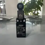 Omron D4NA-4122 — top view showing the centered pin plunger actuator and the 1NC/1NO contact marking on the side label