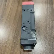 D4SL-N4EFA-DN installed on a hinged guard door showing the switch on the door frame and the D4SL-K1 operation key on the door leaf, the M20 conduit entry, and the orange LED lit when the solenoid is energised