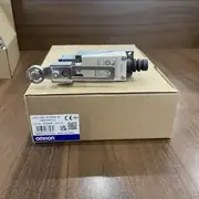 D4V-8108SZ-N switch removed from the box, showing the upright body, adjustable roller lever on the head, and the open conduit entry on the bottom