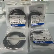 Omron E2E-S05S12-WC-B1 inductive proximity sensor — M5 stainless body with hex locknut and 2 m oil-resistant PVC cable