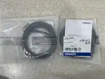Omron E2E-X2ME1 inductive proximity sensor -- label detail on the cable jacket printing the Omron part number E2E-X2ME1 and oil-resistant PVC marking.