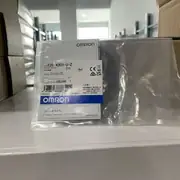 Omron E2E-X3D1-U — top label close-up showing the part number, the 24-240 VAC/VDC free-voltage rating, and the IP67 mark on the nickel-plated brass body