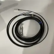 Omron E2EC-C1R5D1 — top view of the inline amplifier block showing the 2-wire DC output cable exit and the operation LED on the housing face