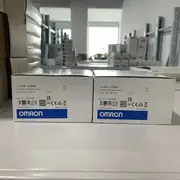 Omron E2K-C25ME1 2M — side profile showing the unshielded M30 barrel, the 18-turn sensitivity potentiometer on the rear of the head, and the cable gland