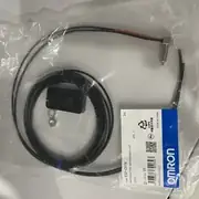 E32-C91N 2M installed in a small bracket with the fiber trimmed to length and seated into a DIN-rail E3X-NA amplifier's fiber lock