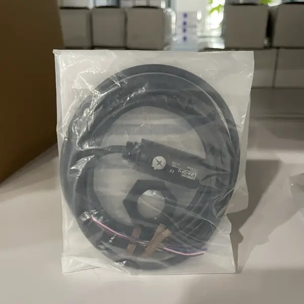 Omron E3FA-DP12 diffuse-reflective photoelectric sensor — M18 ABS plastic barrel with 2 m pre-wired PVC cable visible