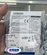 Omron E3FA-DP13 — rear face showing the M12 connector, the cable strain relief, and the orange power / output status LED visible from the back
