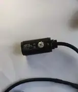Omron E3FA-DP13 — top label close-up showing the part number, the 10-30 VDC rating, the IP67 / IP69K mark, and the wiring pinout on the housing