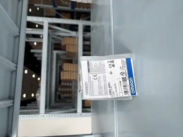 Omron E3FA-DP21 diffuse sensor — sealed plastic bag with Omron specification label showing TYPE E3FA-DP21, Photoelectric Sensor, 10 to 30V DC, Q'TY 1, LOT 11124M, CE and UKCA marks