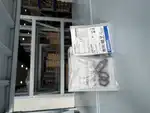 Omron E3FA-DP21 diffuse sensor — three stacked Omron-branded retail bags each labelled E3FA-DP21 / Photoelectric Sensor, showing multiple lot numbers (11124M, 11124AM, 16723M) for inventory tracking
