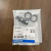 Omron E3FA-RP21 M18 retro-reflective photoelectric sensor — bottom label close-up showing the model number E3FA-RP21, the 4 m sensing range with E39-R1S reflector, the PNP MSR polarized designation, and the IP67/IP69K / CE / cULus certification marks