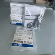 Omron E3FA-TN21 2M — multiple sealed units stacked for packaging and shipping