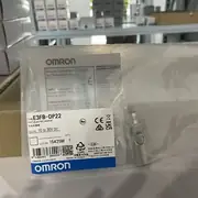 Omron E3FB-DP22 photoelectric sensor — front face with red LED indicator and 18mm threaded brass body
