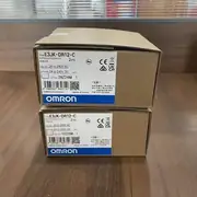 Omron E3JK-DR12-C — rear face showing the single-turn sensitivity potentiometer and the cable strain-relief gland for the 2 m pre-wired lead